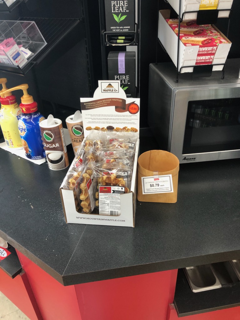 Mountain Waffle Co. individually wrapped waffles on display by a coffee bar
